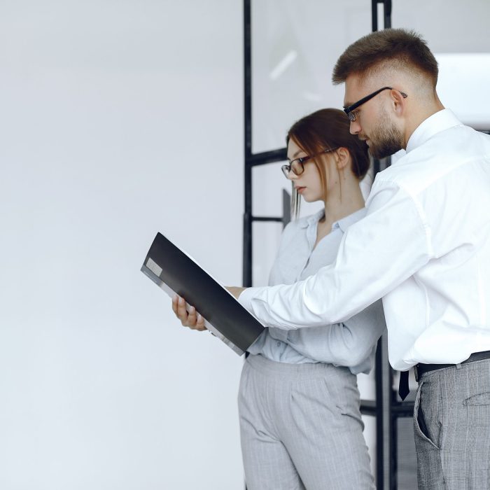 Woman holds a folder. Business partners at a business meeting.People with glasses